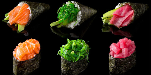 Rolled sushi and hand-rolled sushi sitting below and above each other on a black background