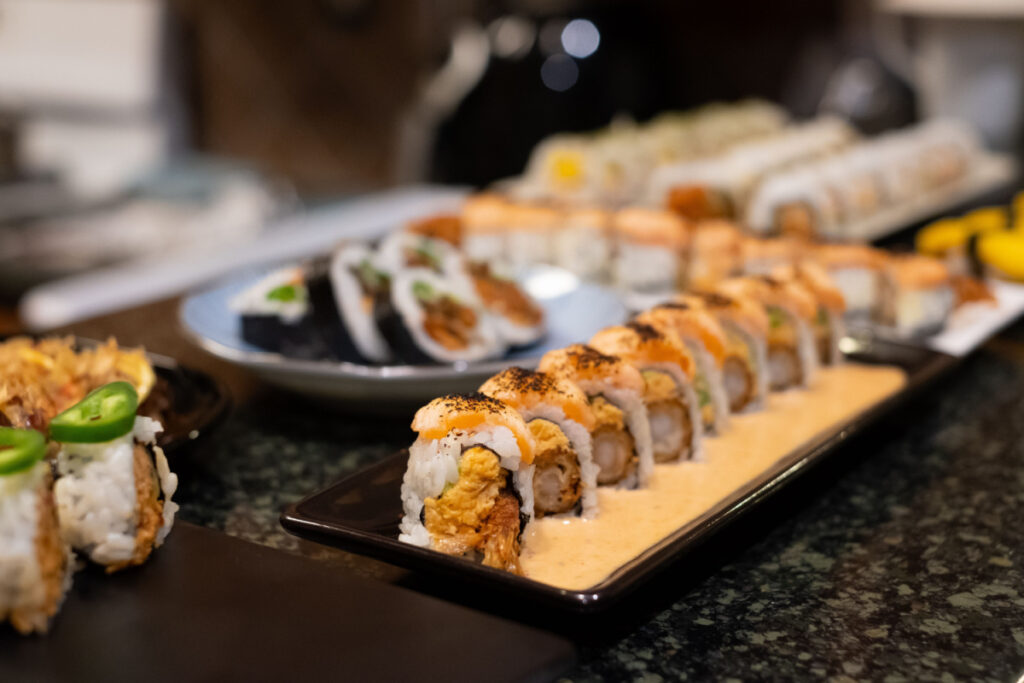 Sushi rolls arranged on plates.